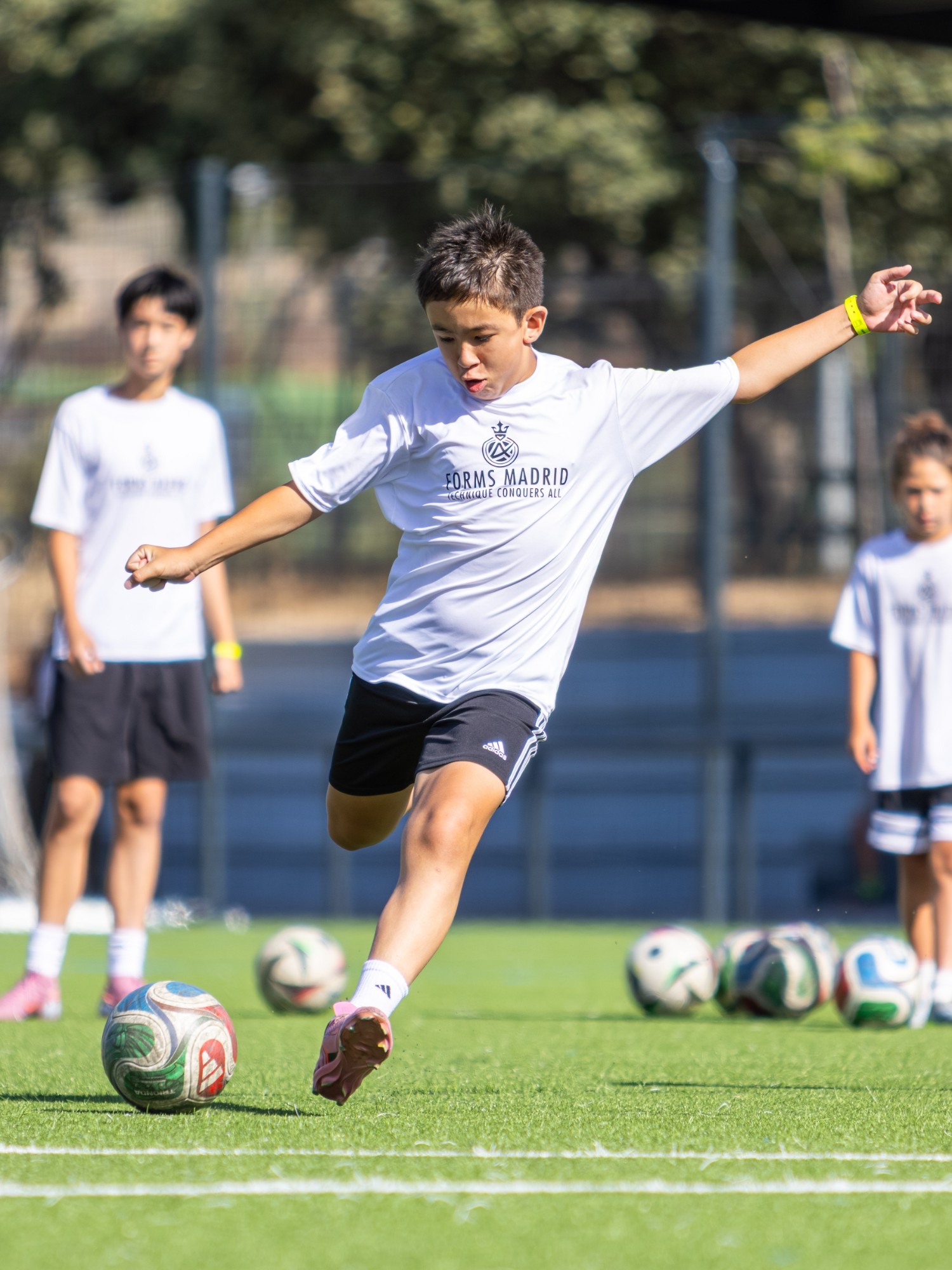A young Forms player striking the ball
